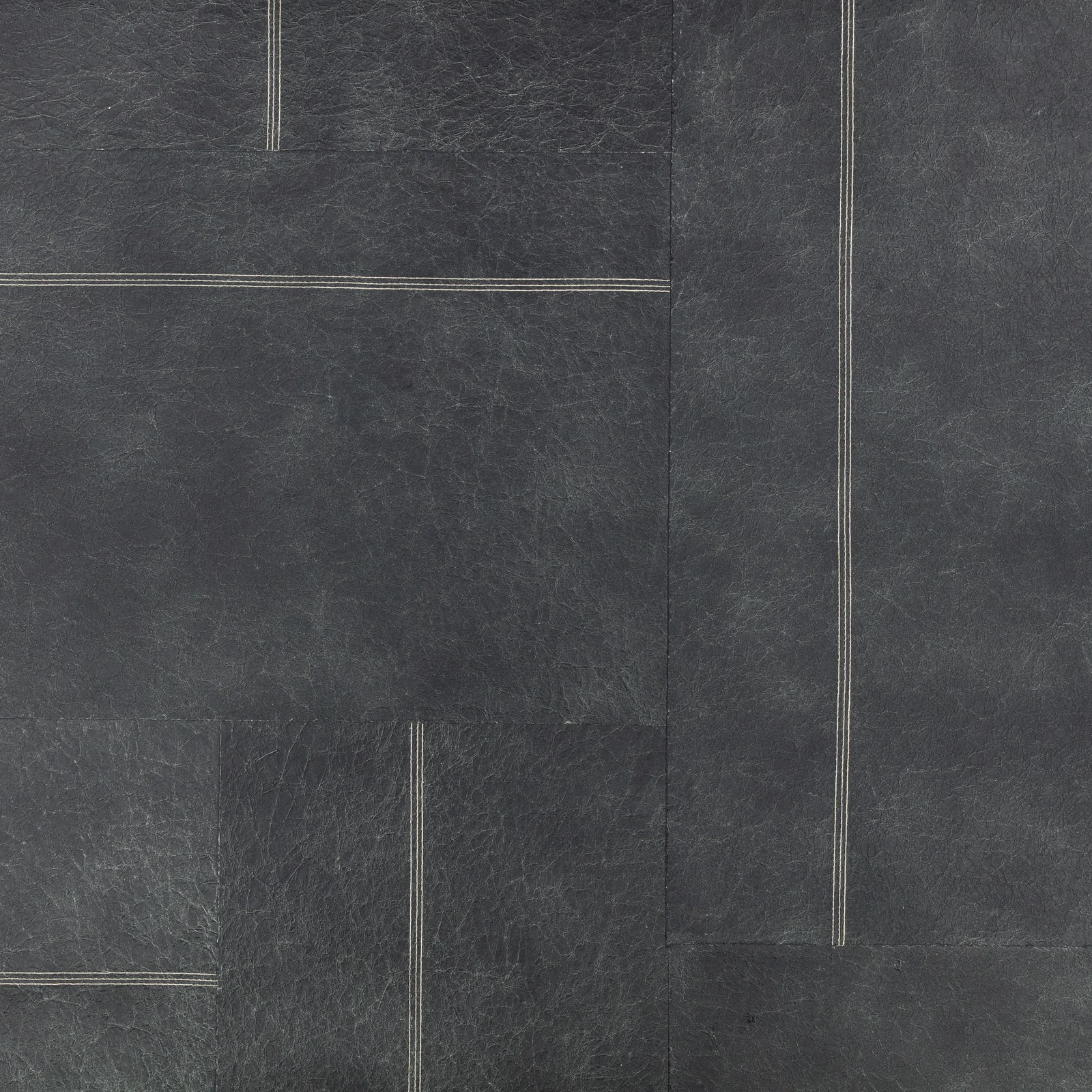Dark indigo wallcovering with pale linear rectangles and a distressed fibrous texture