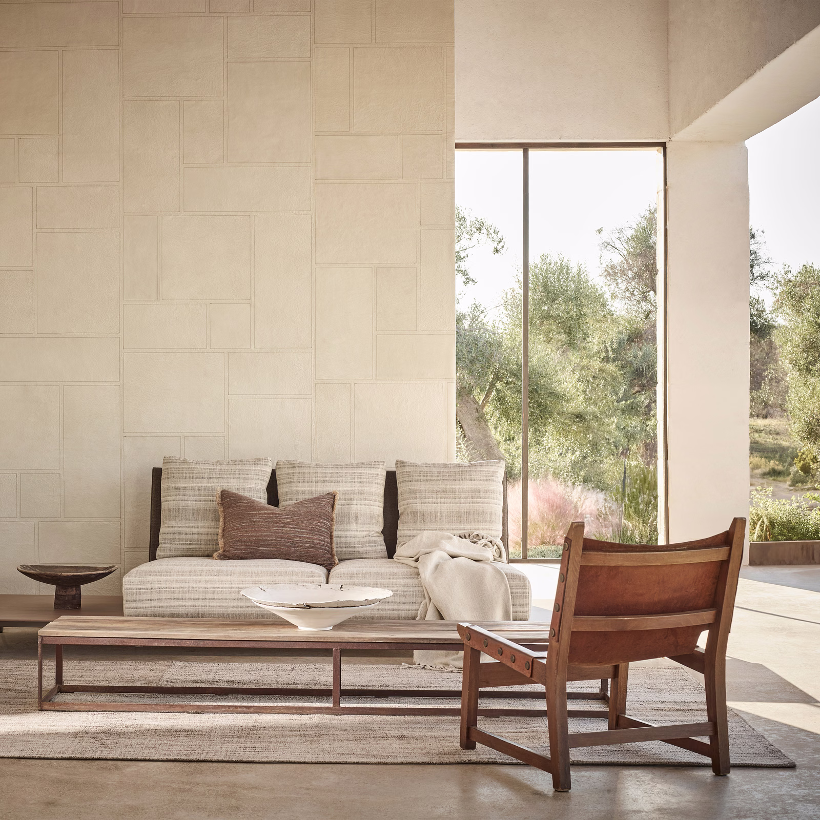 Warm parchment wallpaper with subtle rectangular panels in a sunlit modern room