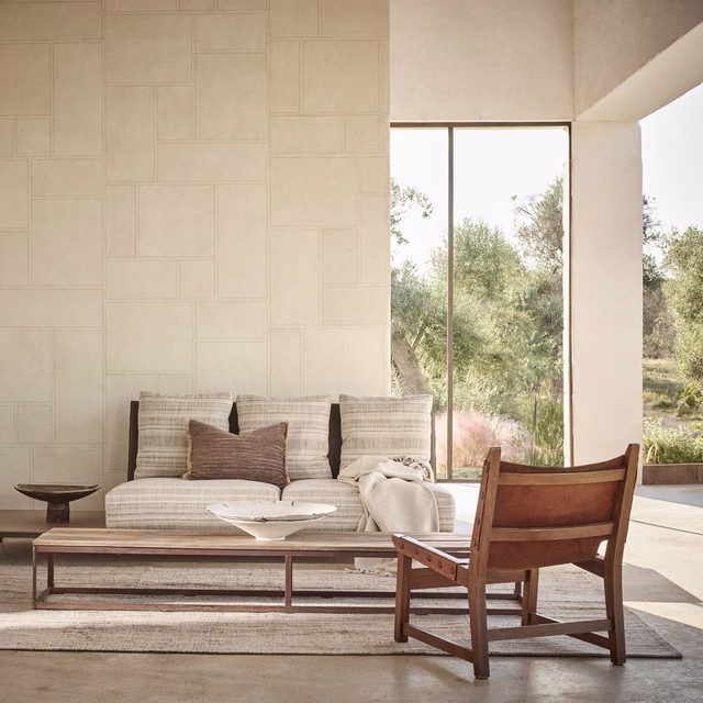 Warm parchment wallpaper with subtle rectangular panels in a sunlit modern room
