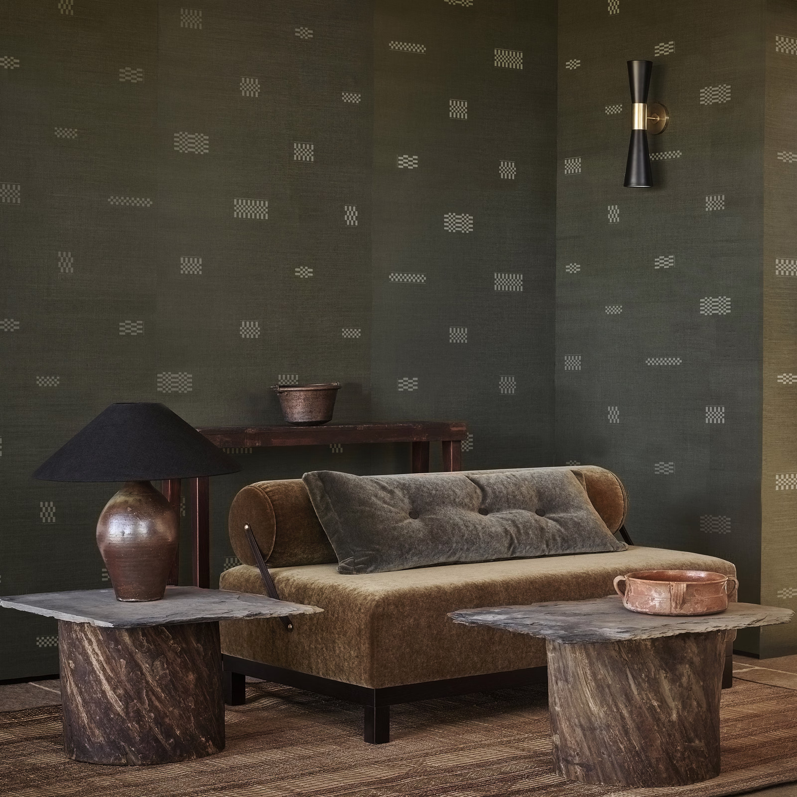 Deep olive wallpaper with scattered pale geometric dash motifs and a softly textured ground