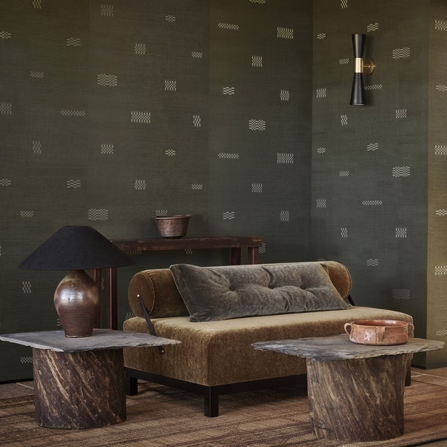 Deep olive wallpaper with scattered pale geometric dash motifs and a softly textured ground