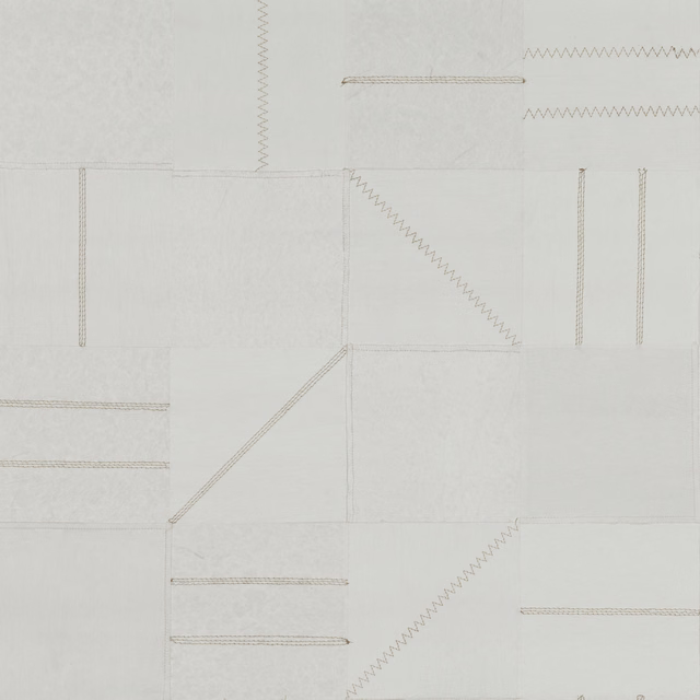 Pale chalk-grey wallpaper with outlined blocks, fine seams and delicate zigzag lines