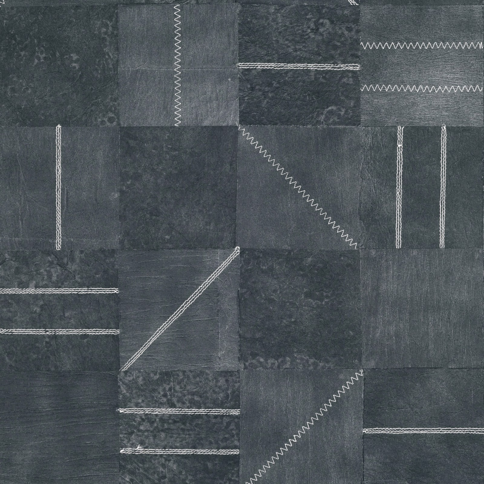 Charcoal indigo patchwork wallpaper with mottled blocks and pale zigzag stitched lines