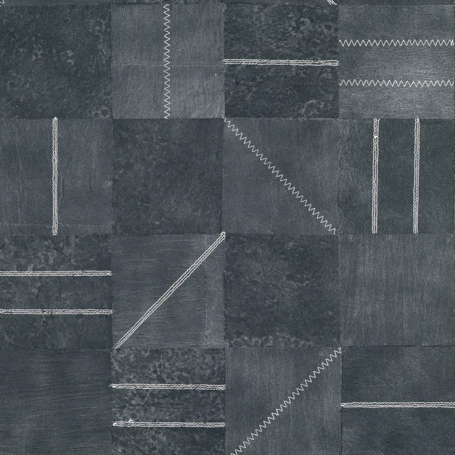 Charcoal indigo patchwork wallpaper with mottled blocks and pale zigzag stitched lines
