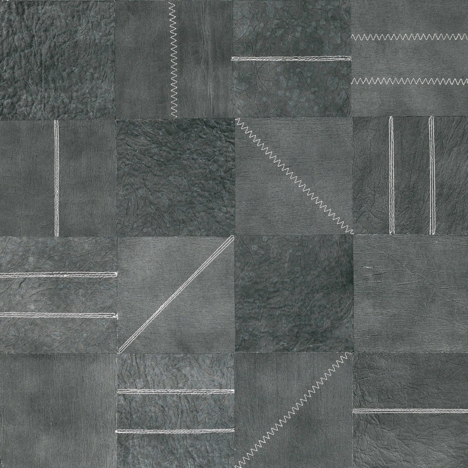 Cool grey-green wallpaper swatch with mottled panels and contrasting zigzag stitch lines
