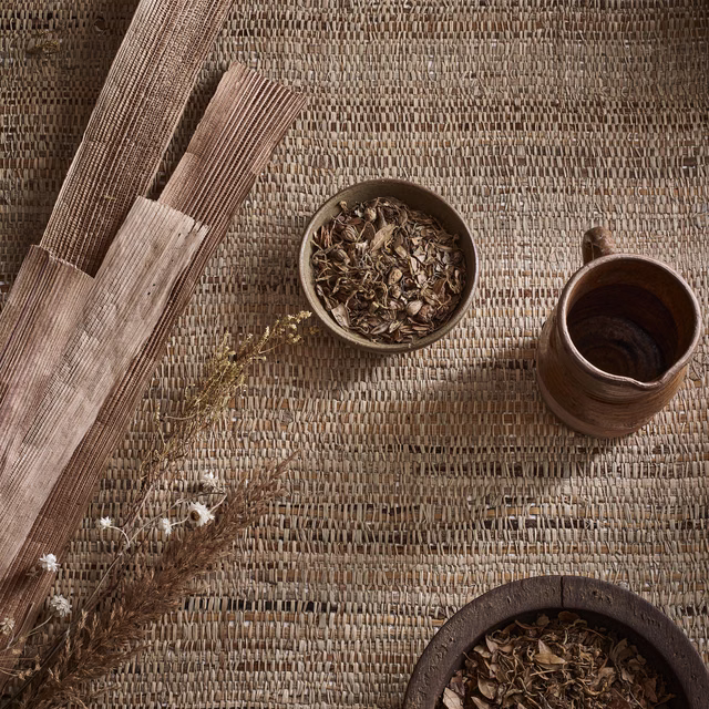 Warm taupe natural wallpaper showing irregular woven fibres and bark-like tonal variation