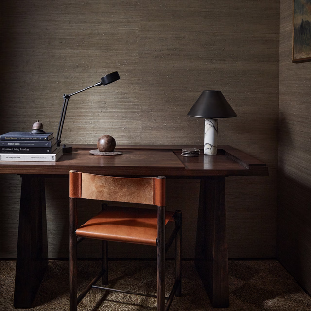 Warm taupe-brown grasscloth wallcovering with fine horizontal fibres in a dark study
