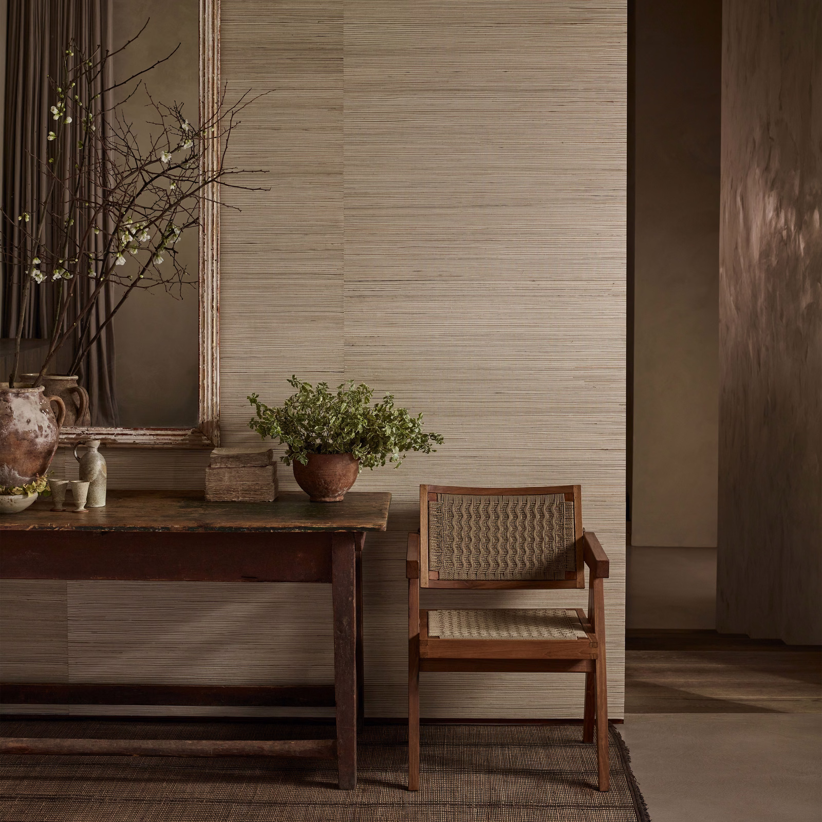 Warm taupe reed-like wallpaper with fine horizontal striations in a serene dining room