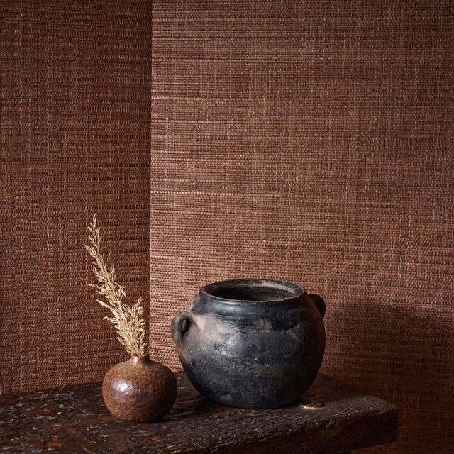 Warm paprika-brown woven wallpaper with fine horizontal texture and subtle tonal variation