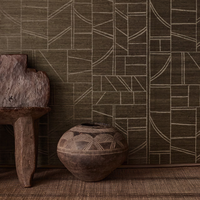 Dark loam-brown wallpaper with pale geometric lines over a fibrous horizontal ground