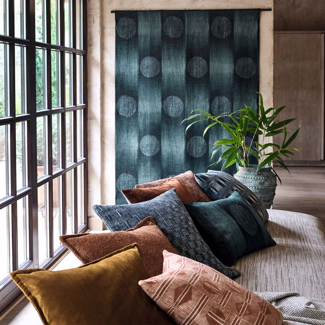 Deep blue-teal woven fabric with charcoal circles and vertical strié texture