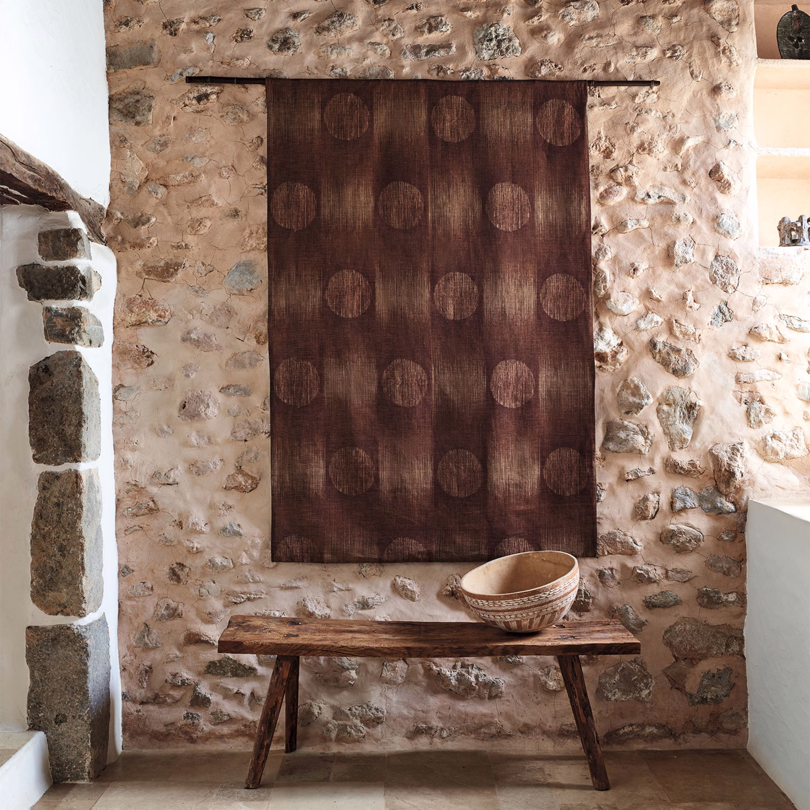 Warm sienna-brown textile panel with tonal circles and fine vertical striations