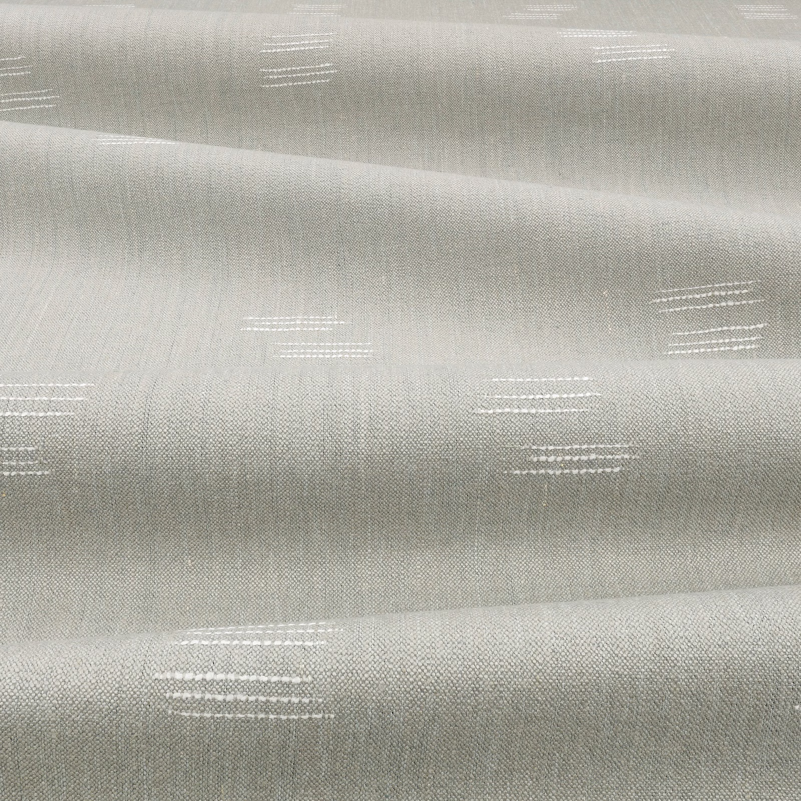 Pale cool-grey woven cloth with broken white horizontal dash motifs and soft sheen