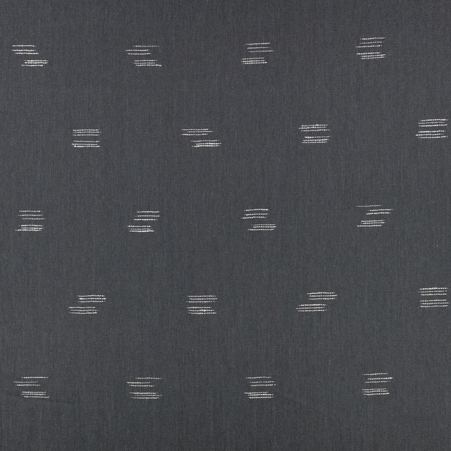 Deep indigo woven fabric with small pale horizontal motifs in a staggered grid