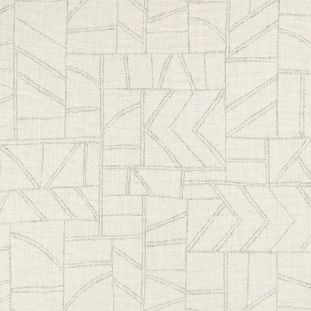 Pale dove-grey woven fabric with subtle geometric patchwork lines and chevron panels