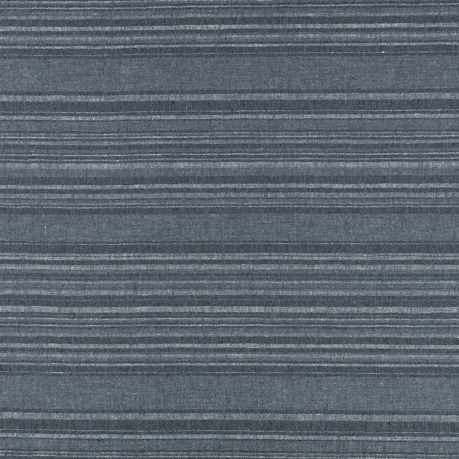 Close-up of indigo-blue woven fabric with irregular horizontal grey striations