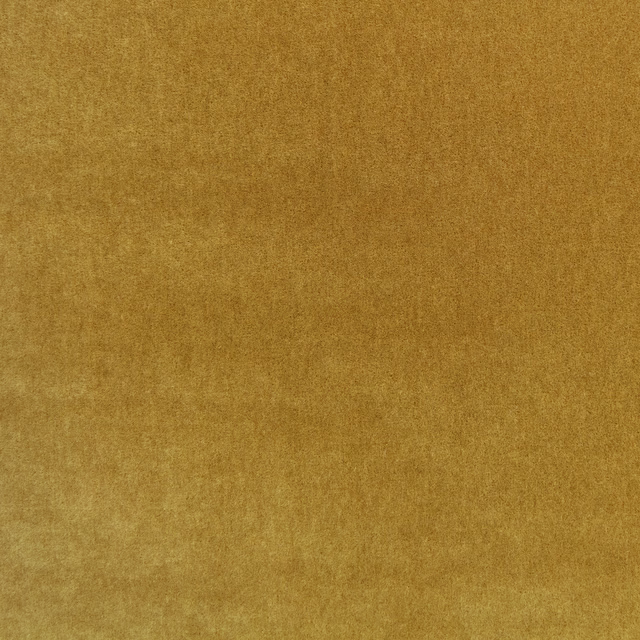 Warm ochre plush fabric with softly mottled shading and a tactile low pile