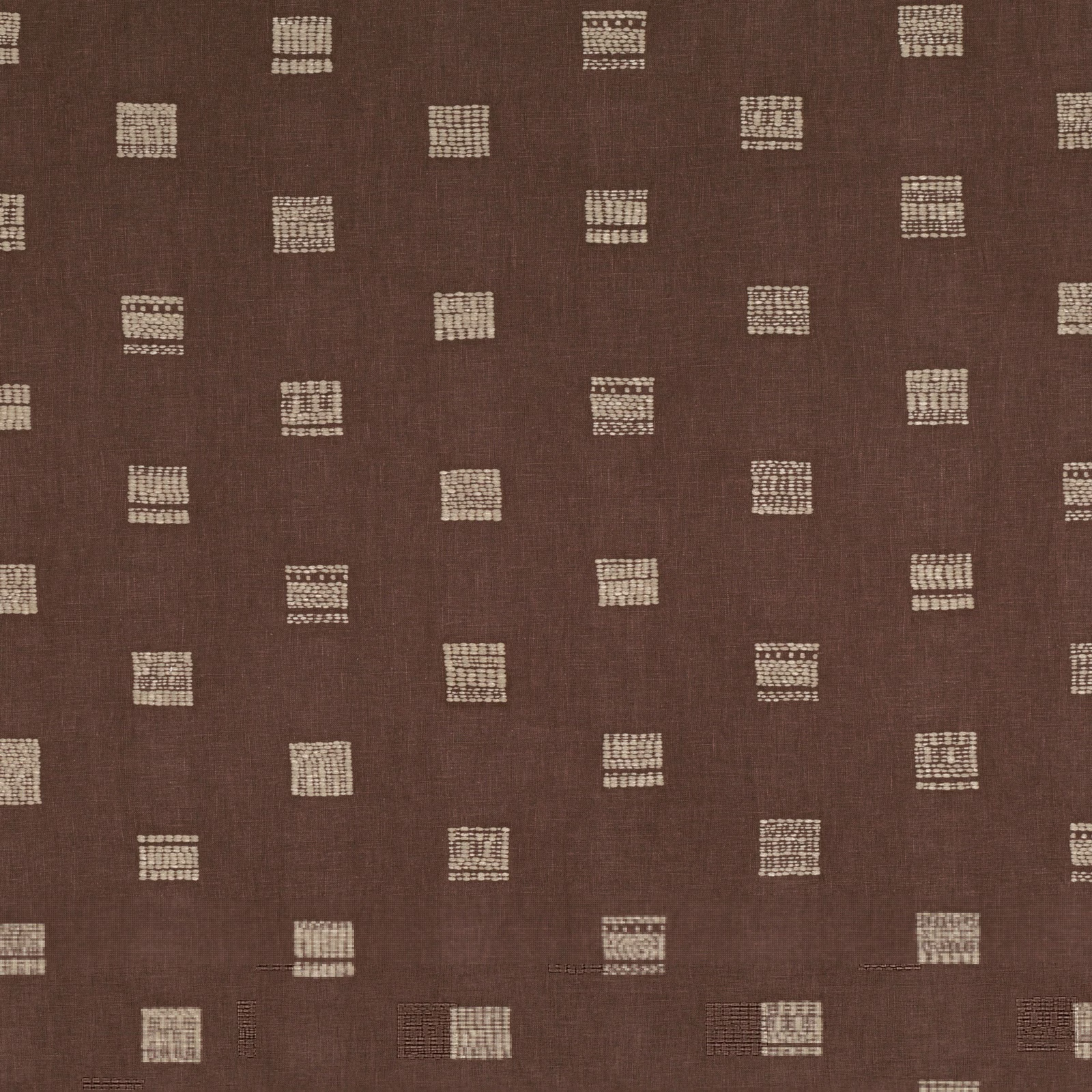 Sienna-brown woven fabric with scattered small cream rectangular motifs