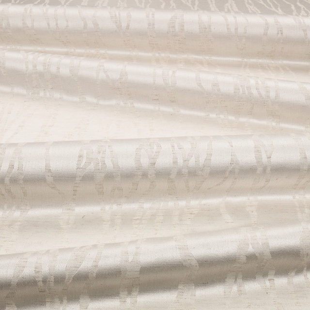 Eggshell ivory fabric with softly lustrous woven folds and blurred vertical striations