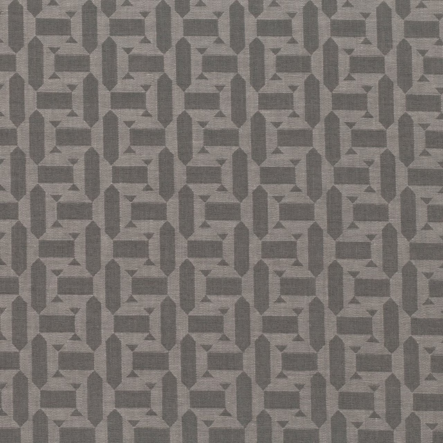 Anthracite-grey woven geometric textile with interlocking octagons and stepped linear motifs