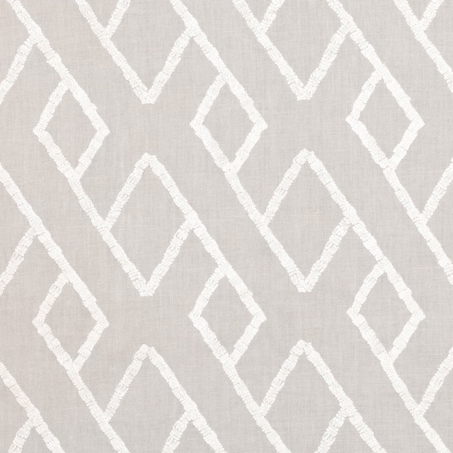 Pale silvery-grey woven ground with raised ivory interlocking diamond embroidery