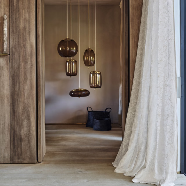 Pale French grey curtain with delicate scrolling botanical texture and soft pooling folds