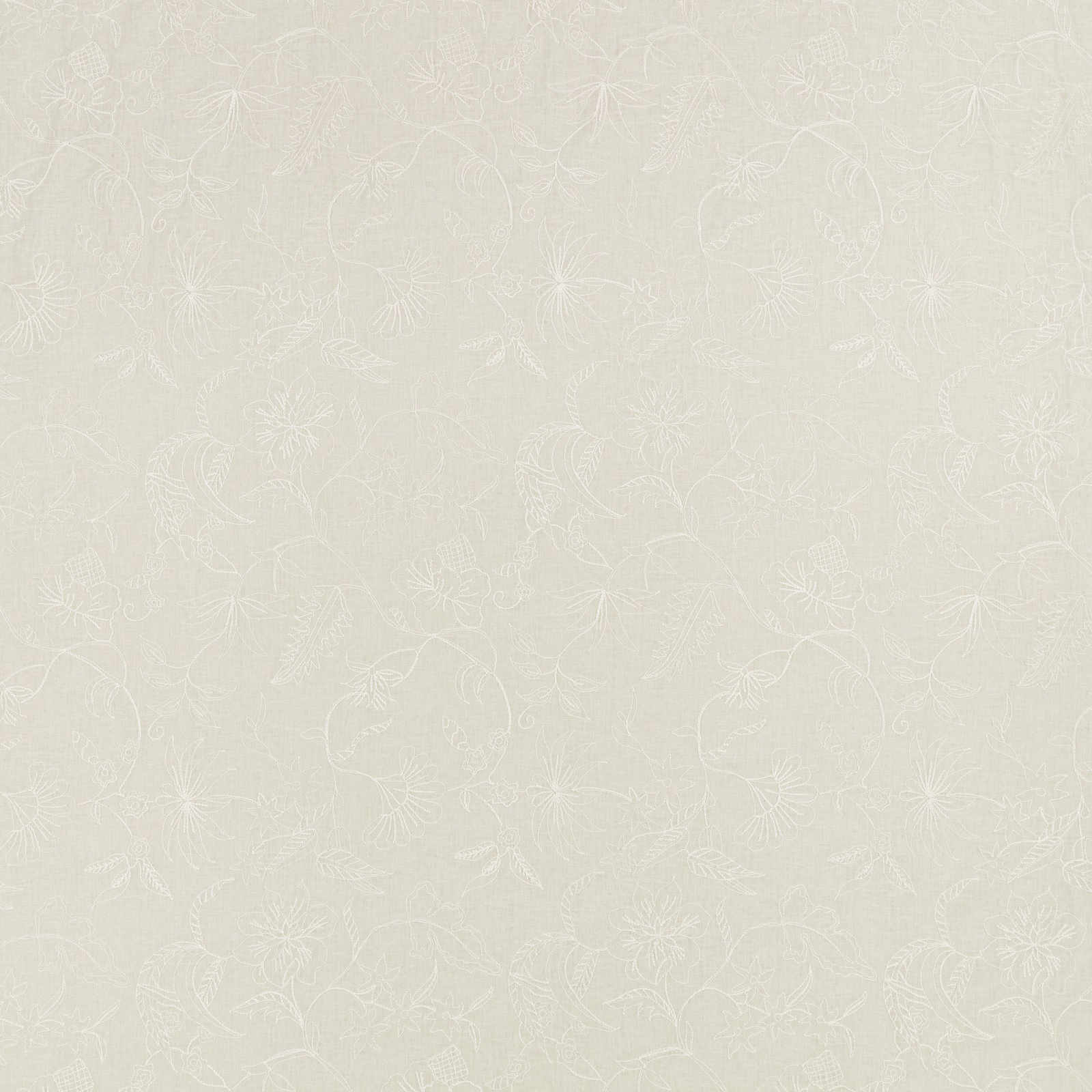 Pale ivory fabric with delicate white floral embroidery and scrolling stems
