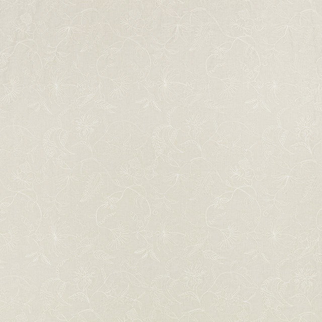 Pale ivory fabric with delicate white floral embroidery and scrolling stems