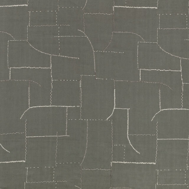 Metal-grey woven fabric with pale stitched, irregular patchwork lines