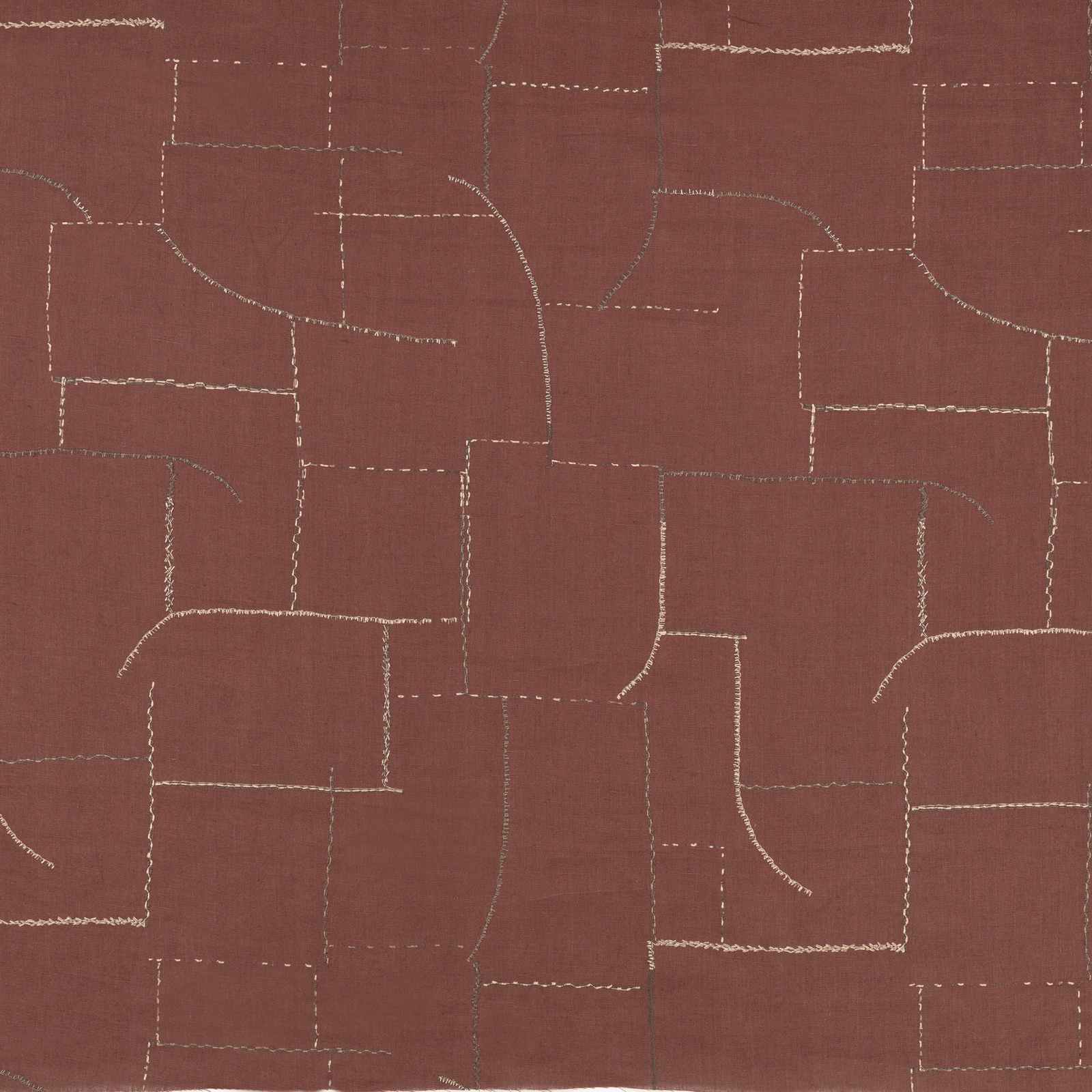 Warm sienna fabric with pale embroidered lines forming an irregular geometric grid