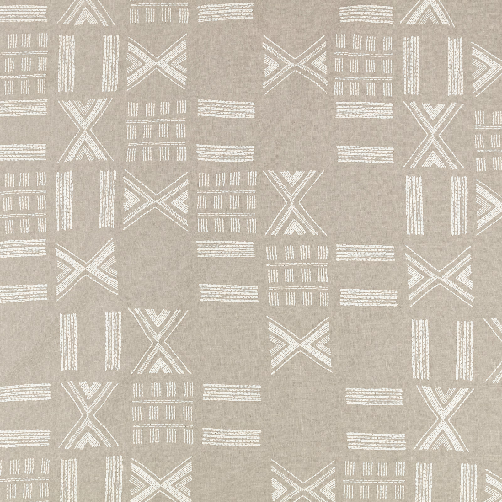 Warm flax-taupe textile with white embroidered Xs, bars and gridded geometric motifs