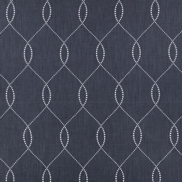 Deep indigo fabric with pale dotted ogee lattice and subtle vertical woven texture