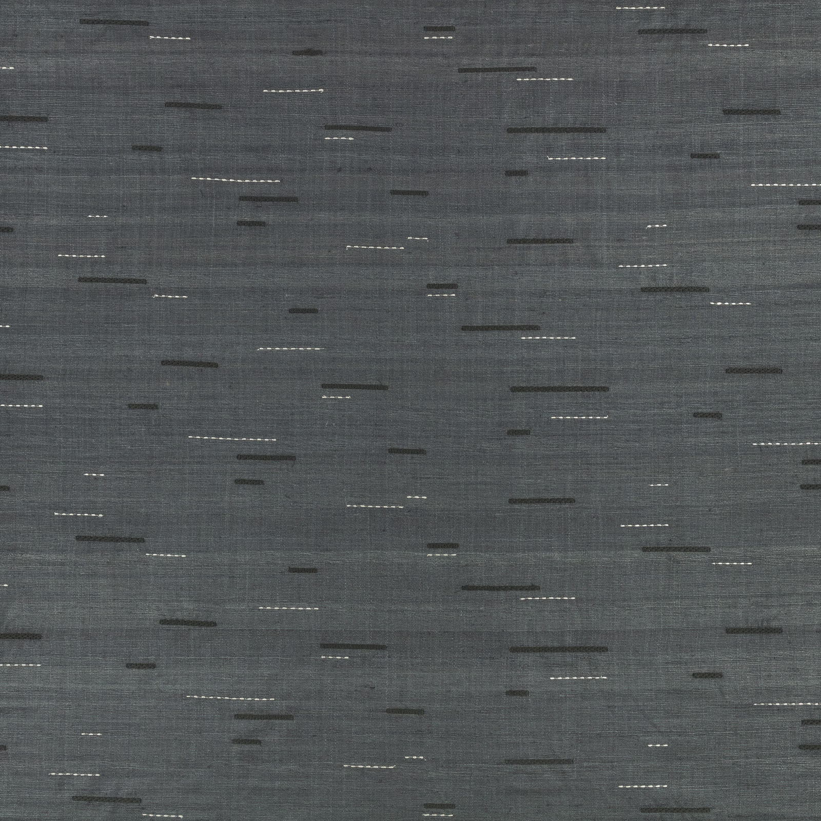 Smoky indigo-grey woven fabric with scattered dark and pale horizontal stitched dashes