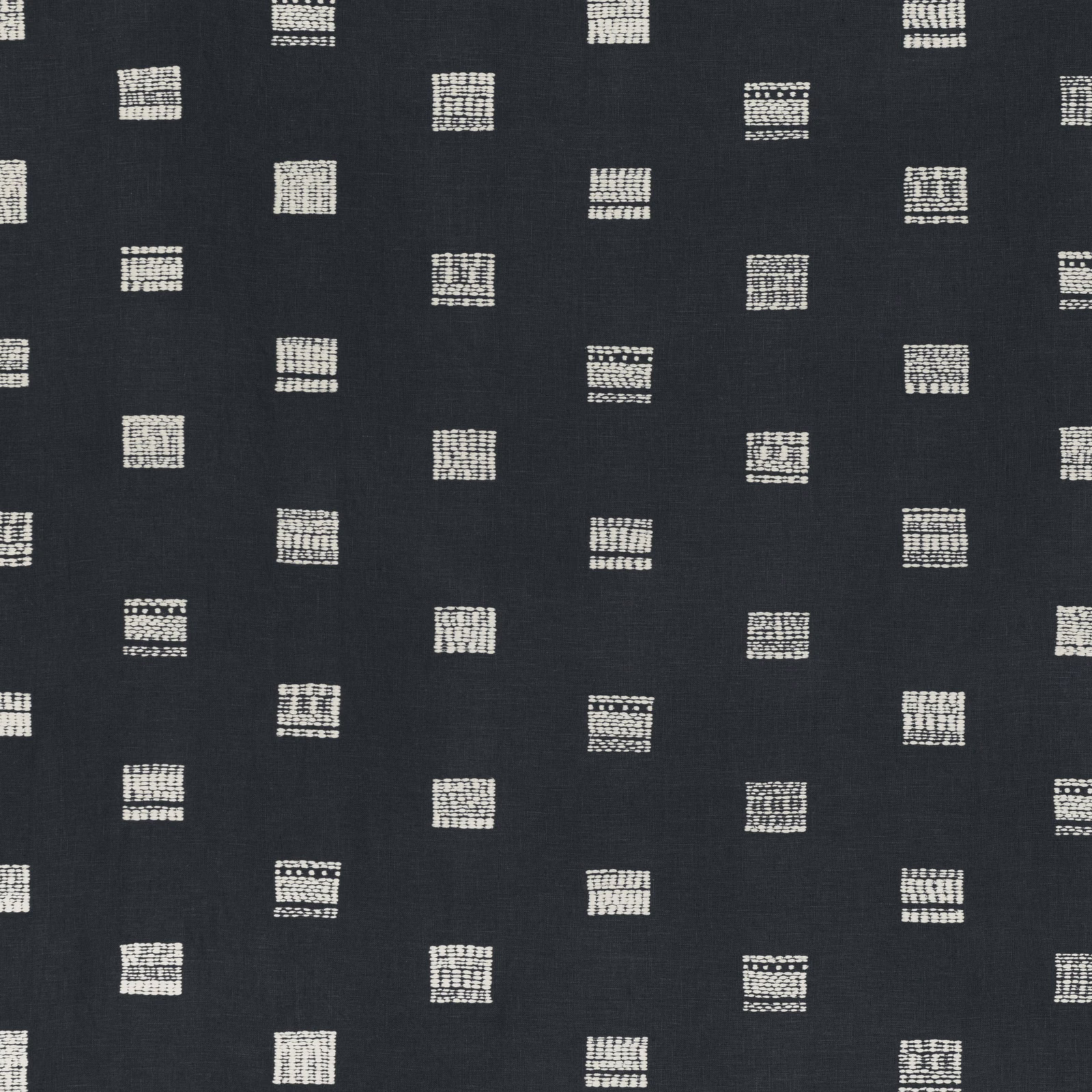 Dark indigo cloth with scattered cream grid-like square motifs and subtle woven texture