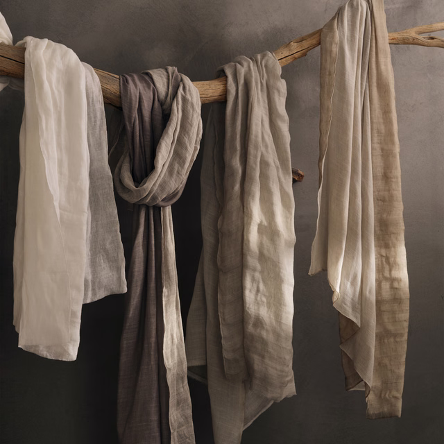 Warm ivory-white sheer with crinkled linen texture hanging in soft vertical folds