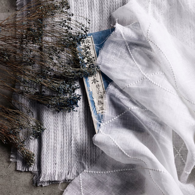 Translucent white sheer with raised dotted grid lines and airy open weave