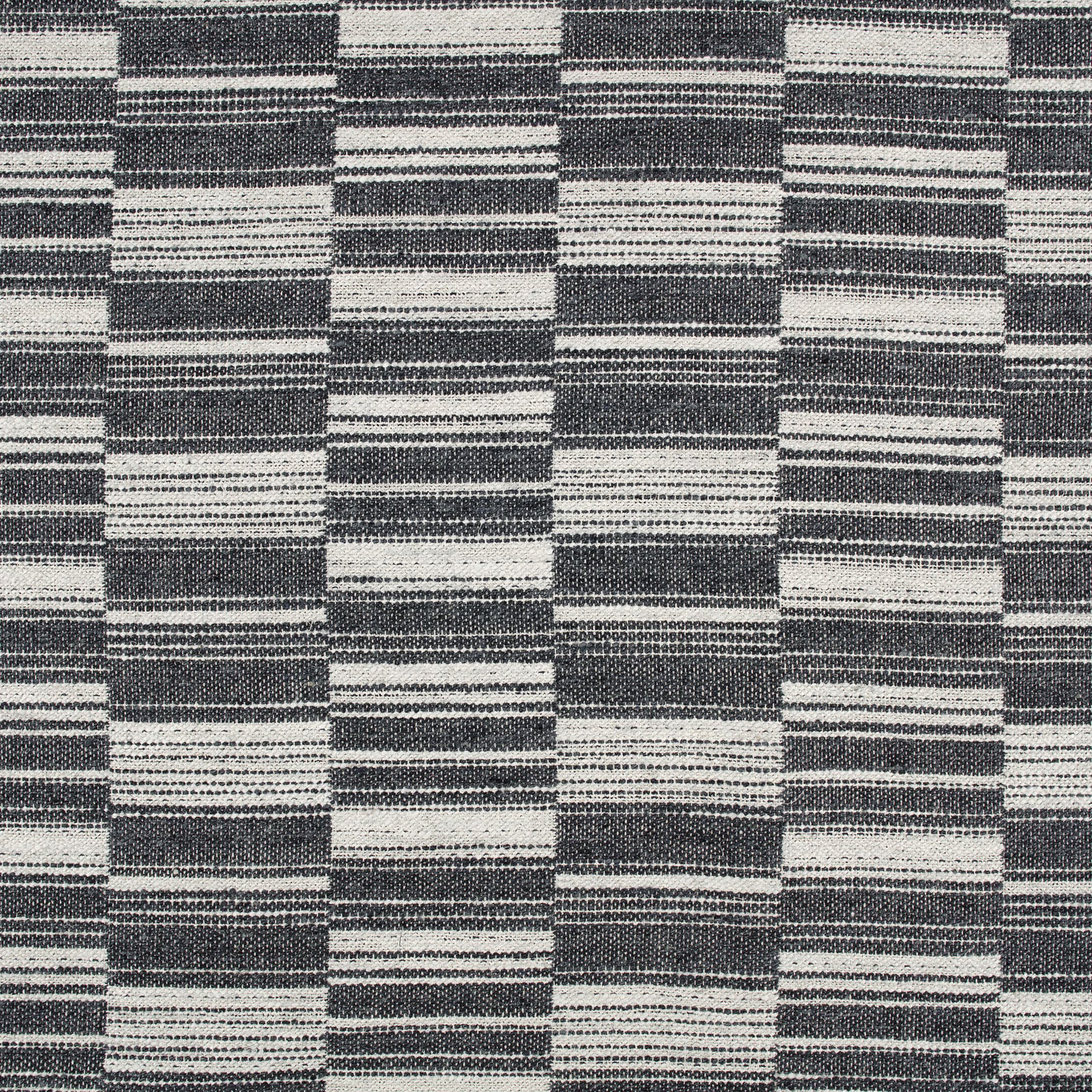 Deep indigo and ivory woven textile with staggered horizontal block stripes