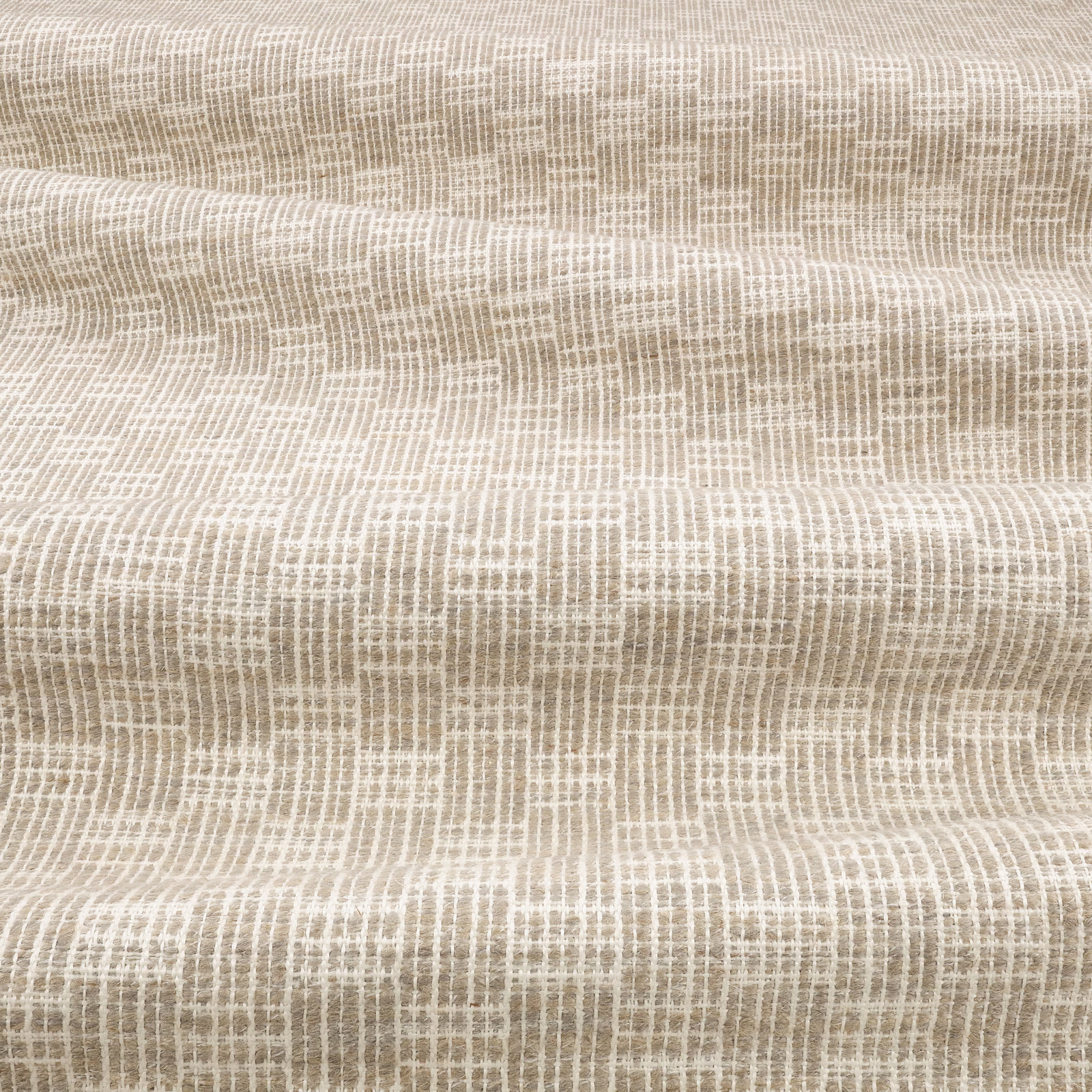 Warm greige woven textile showing a small, irregular crisscross brush texture