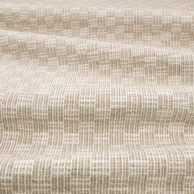 Warm greige woven textile showing a small, irregular crisscross brush texture