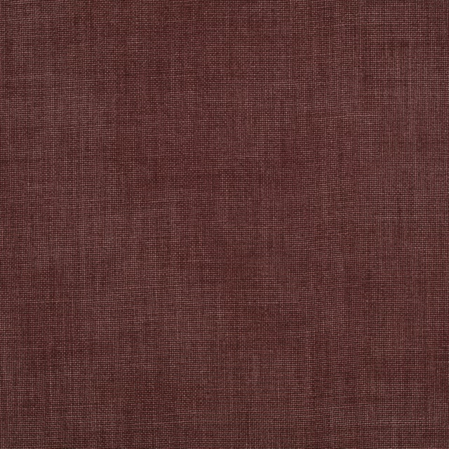 Close-up of muted sienna-brown fabric with a fine crosshatched woven texture