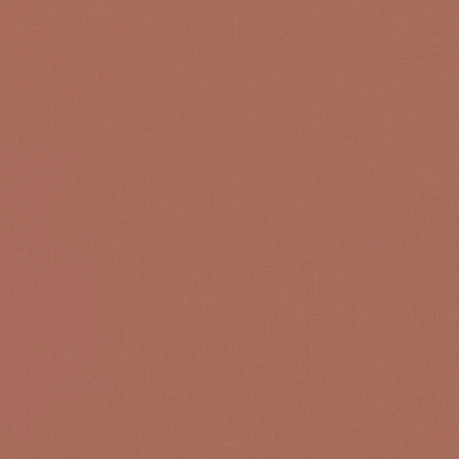 Close-up of muted red-sand terracotta fabric with a fine, even plain weave