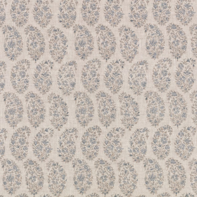 Pale cream textile with dusty blue floral medallions and grey-beige botanical detail