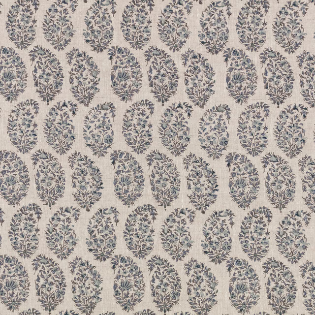 Cream textile with repeating muted indigo botanical medallions and leafy floral detail