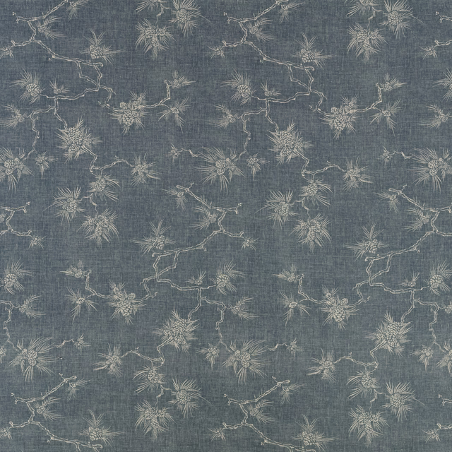 Blue-grey indigo fabric with pale botanical sprays and fine crosshatched texture