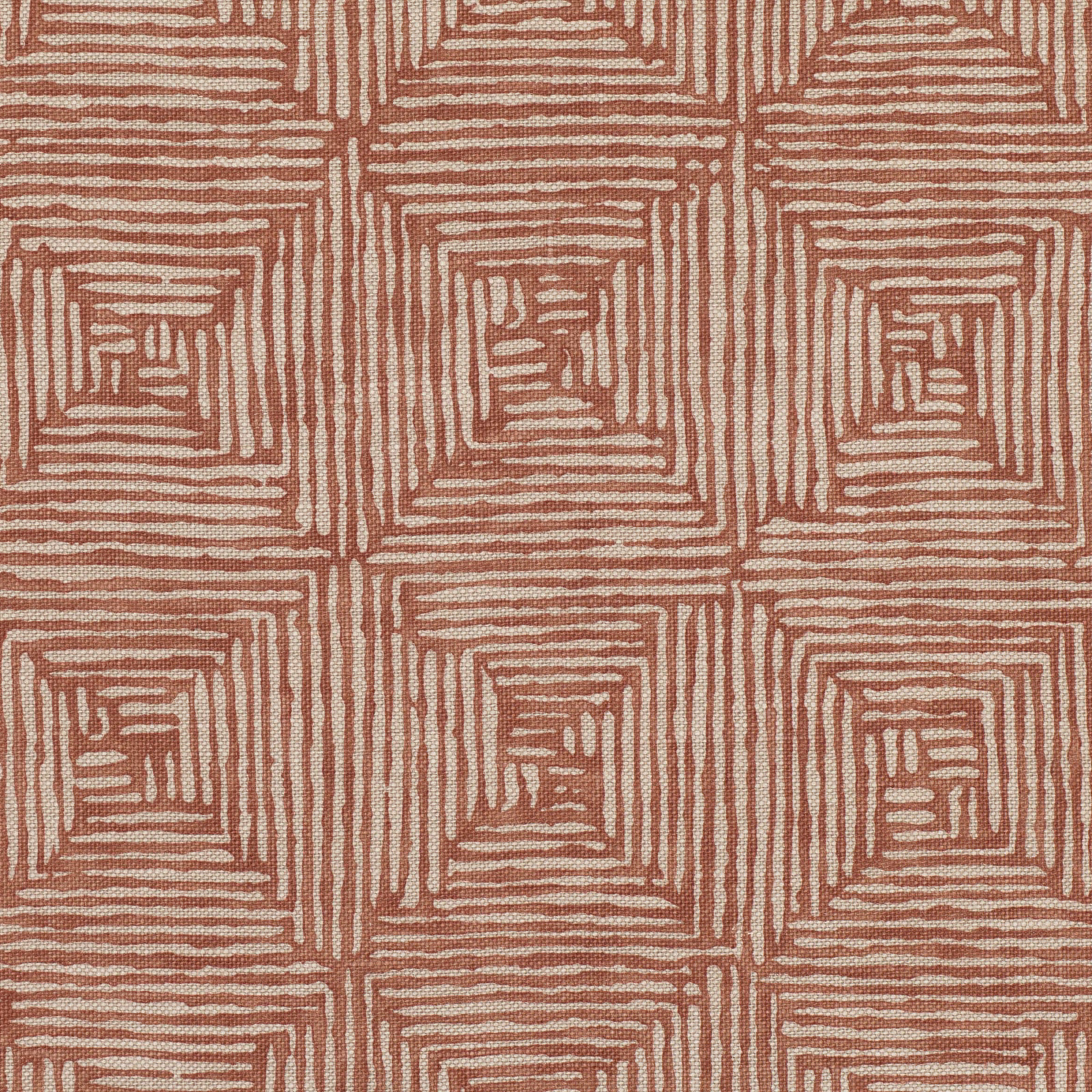 Burnt-orange fabric with ivory nested square lines forming a geometric maze pattern