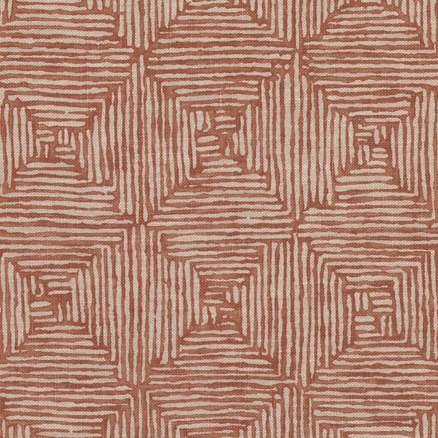 Burnt-orange fabric with ivory nested square lines forming a geometric maze pattern