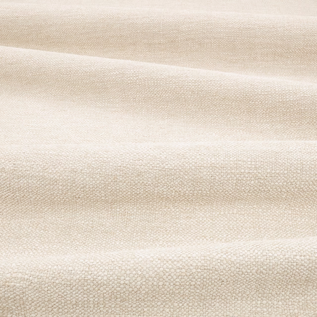 Warm fossil-beige textile with tiny pebbled weave and softly shifting horizontal folds