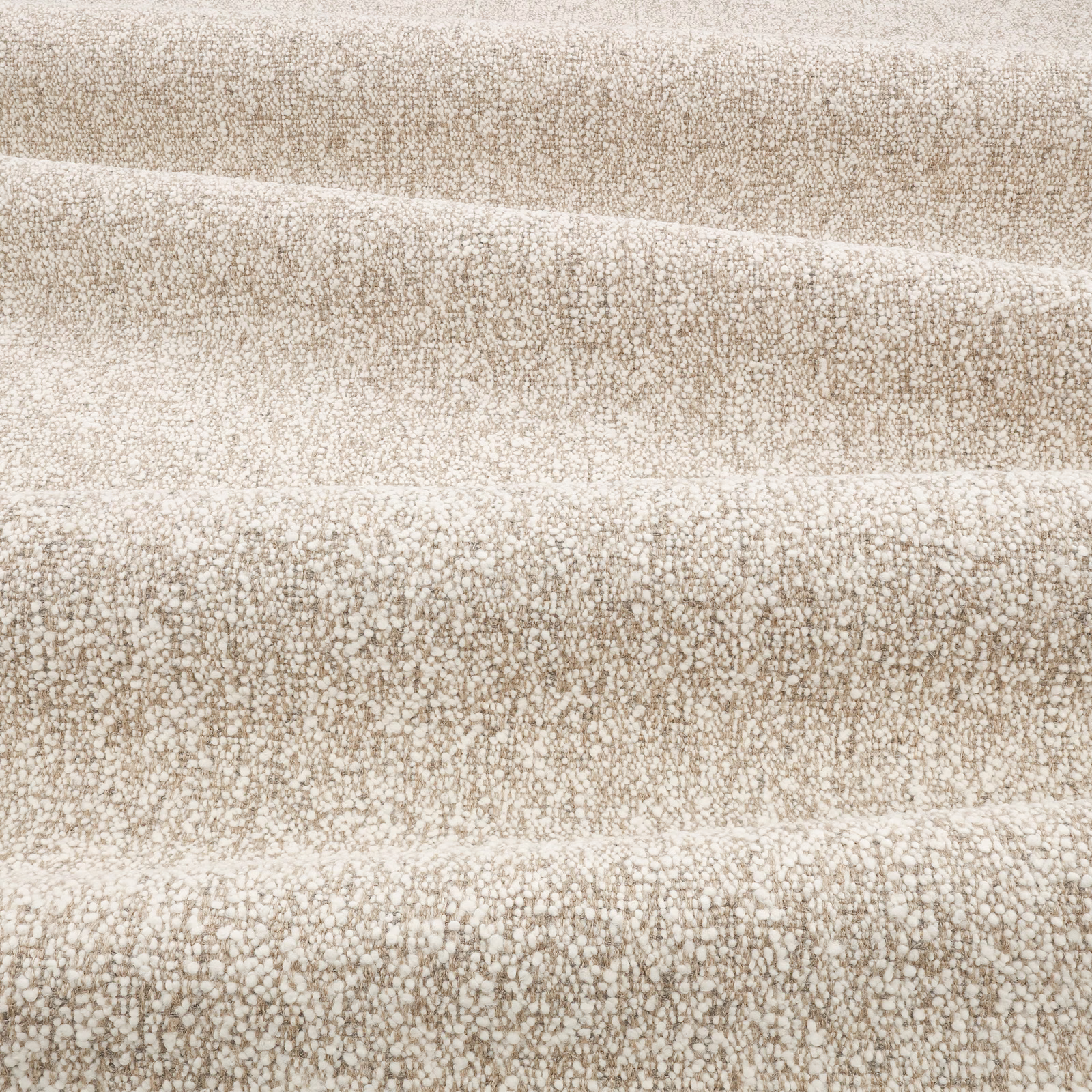 Warm parchment-beige woven textile with nubby mottled texture in horizontal folds