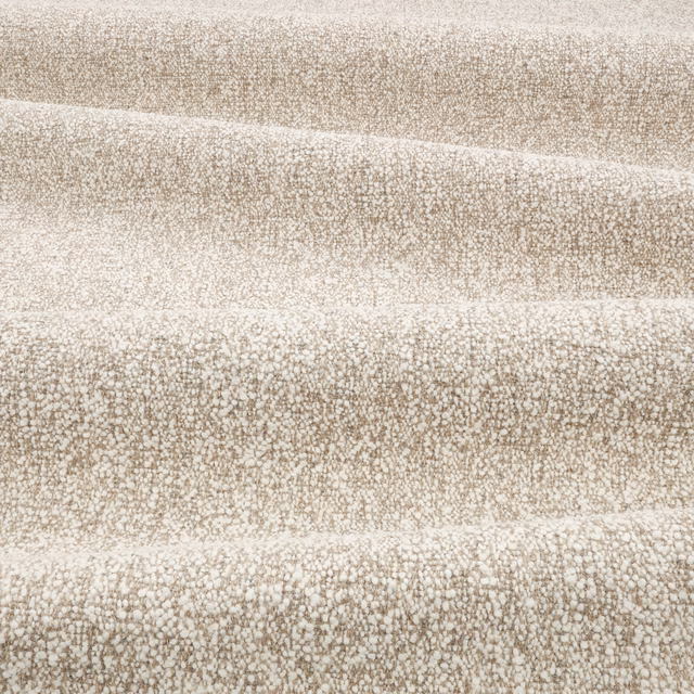 Warm parchment-beige woven textile with nubby mottled texture in horizontal folds