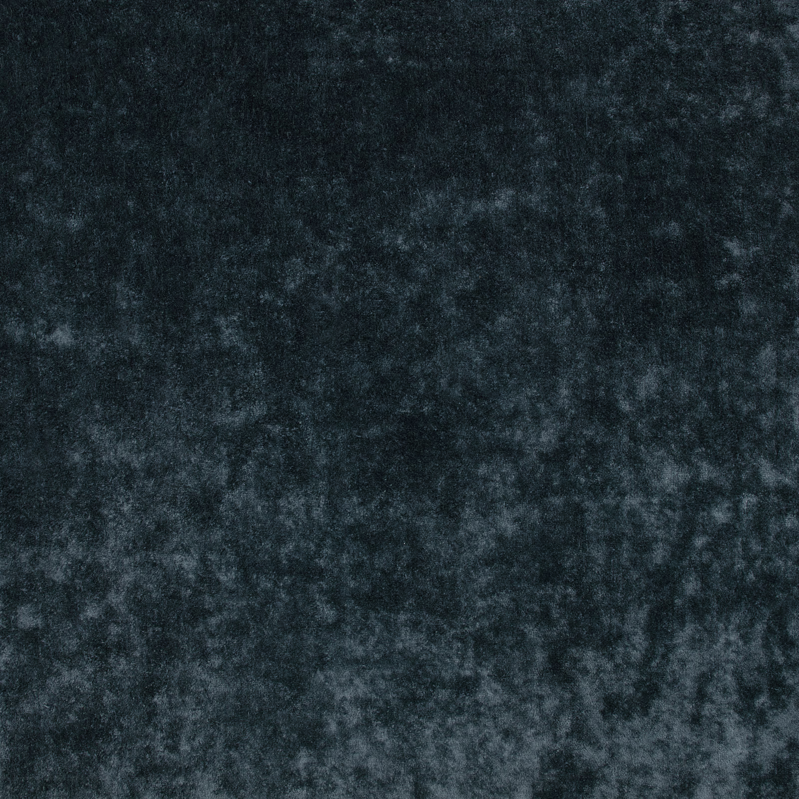 Close-up of deep blueberry blue velvet with smoky mottled pile and soft light-catching texture